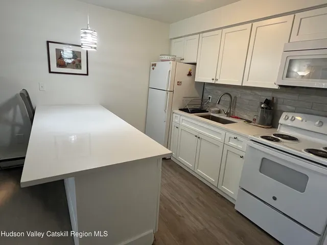 a kitchen with stainless steel appliances a refrigerator sink and cabinets
