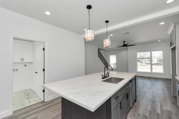 a kitchen with a counter a sink and refrigerator
