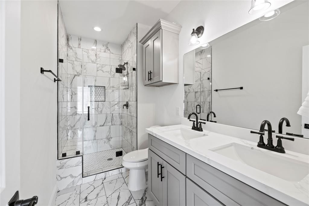 8636 Scott Street, Unit A Houston, TX 77051 - Photo 18 of 21 a bathroom with a sink toilet a mirror and shower