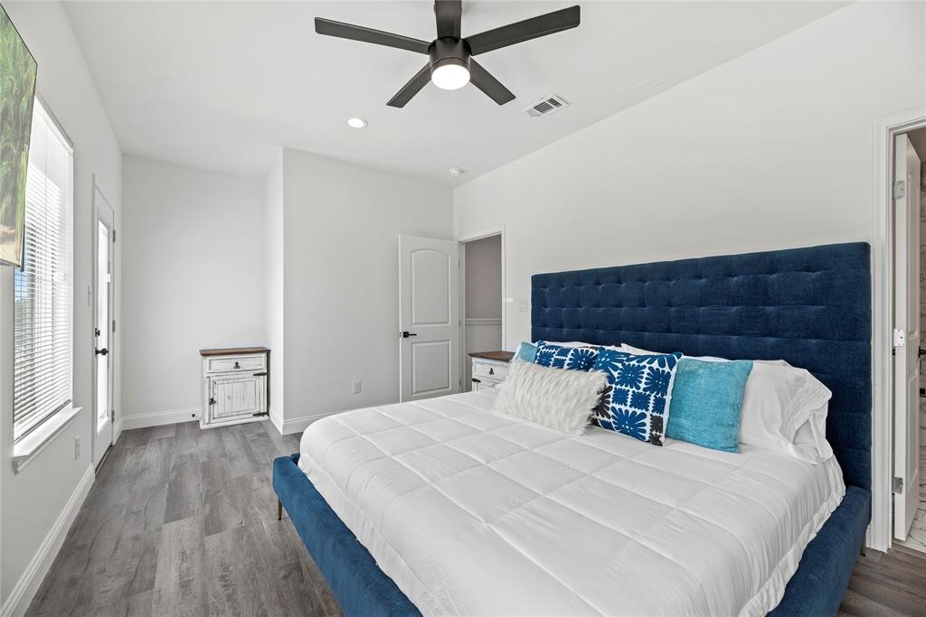 8636 Scott Street, Unit A Houston, TX 77051 - Photo 19 of 21 a bedroom with a bed and wooden floor