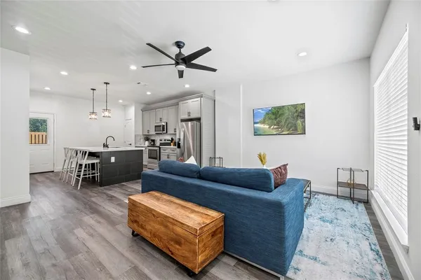 a living room with furniture and kitchen view