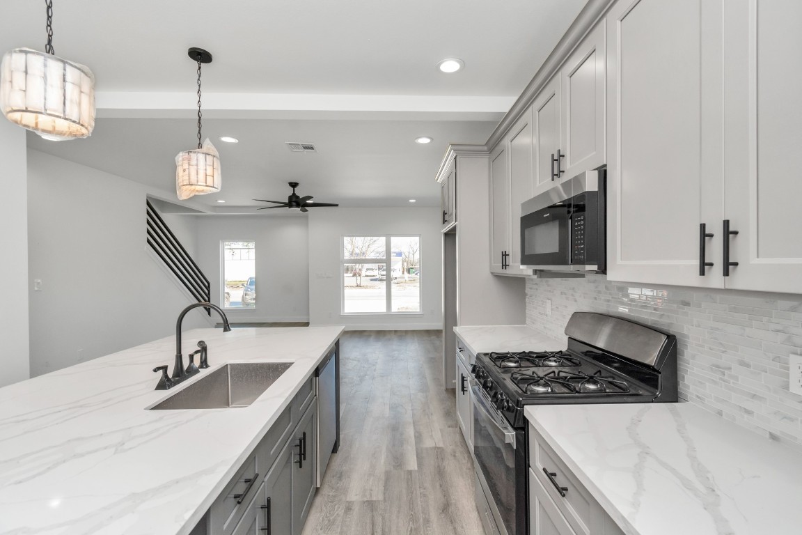 8636 Scott Street, Unit A Houston, TX 77051 - Photo 5 of 21 a kitchen with stainless steel appliances granite countertop a sink stove and refrigerator