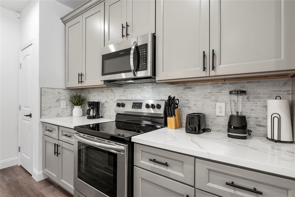 8636 Scott Street, Unit A Houston, TX 77051 - Photo 7 of 21 a kitchen with stainless steel appliances granite countertop white cabinets a stove a sink and dishwasher