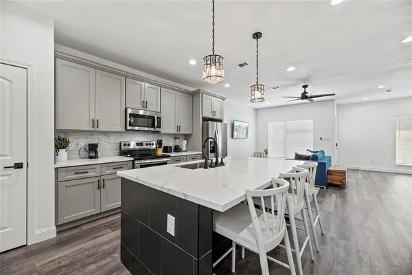a view of kitchen with sink table and chairs
