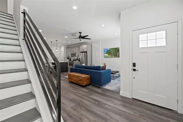 a living room with furniture and a wooden floor