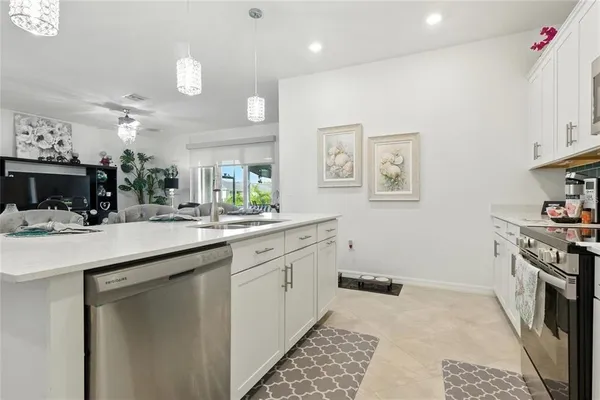 a kitchen with a sink stove and cabinets