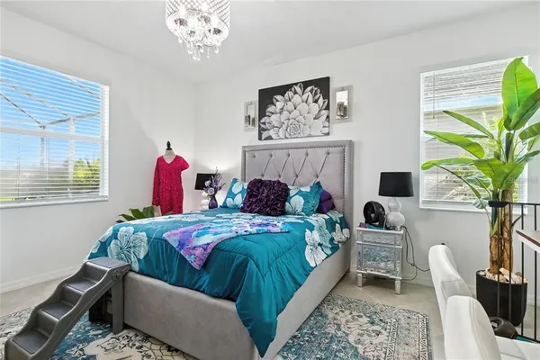 a bedroom with bed and a potted plant