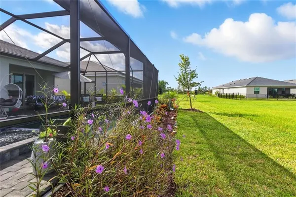 a view of a house with a big yard and potted plants