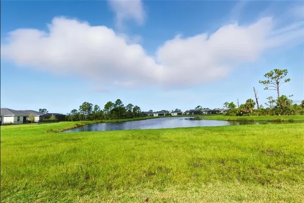a view of a lake with houses in the back