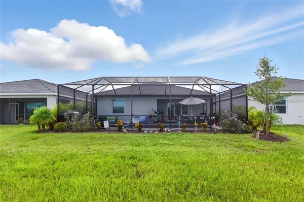 a view of a house with a yard and sitting area