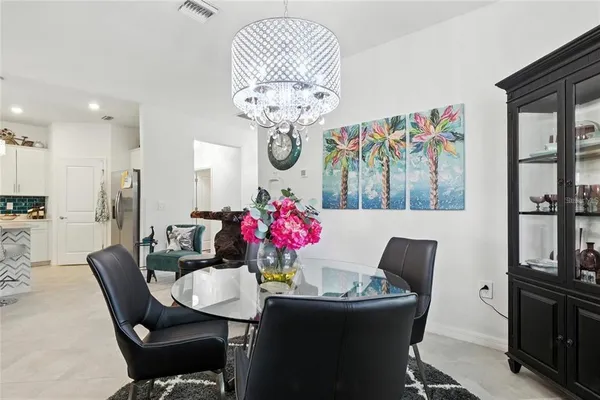a dining room with furniture and chandelier