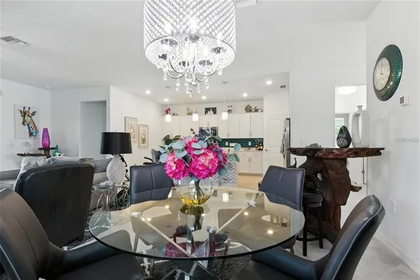 a view of a dining room with furniture and a chandelier