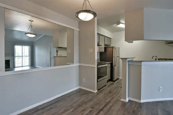 a open kitchen with a refrigerator and dishwasher