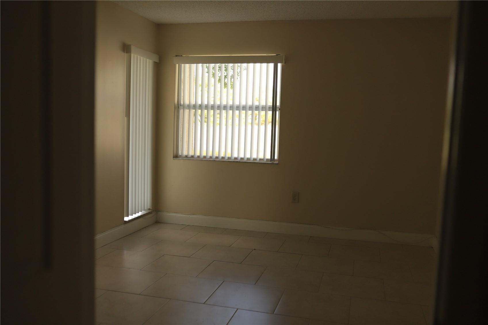 231 Southwest 113th Way, Unit 231 Pembroke Pines, FL 33025 - Photo 16 of 26 a view of an empty room with a window
