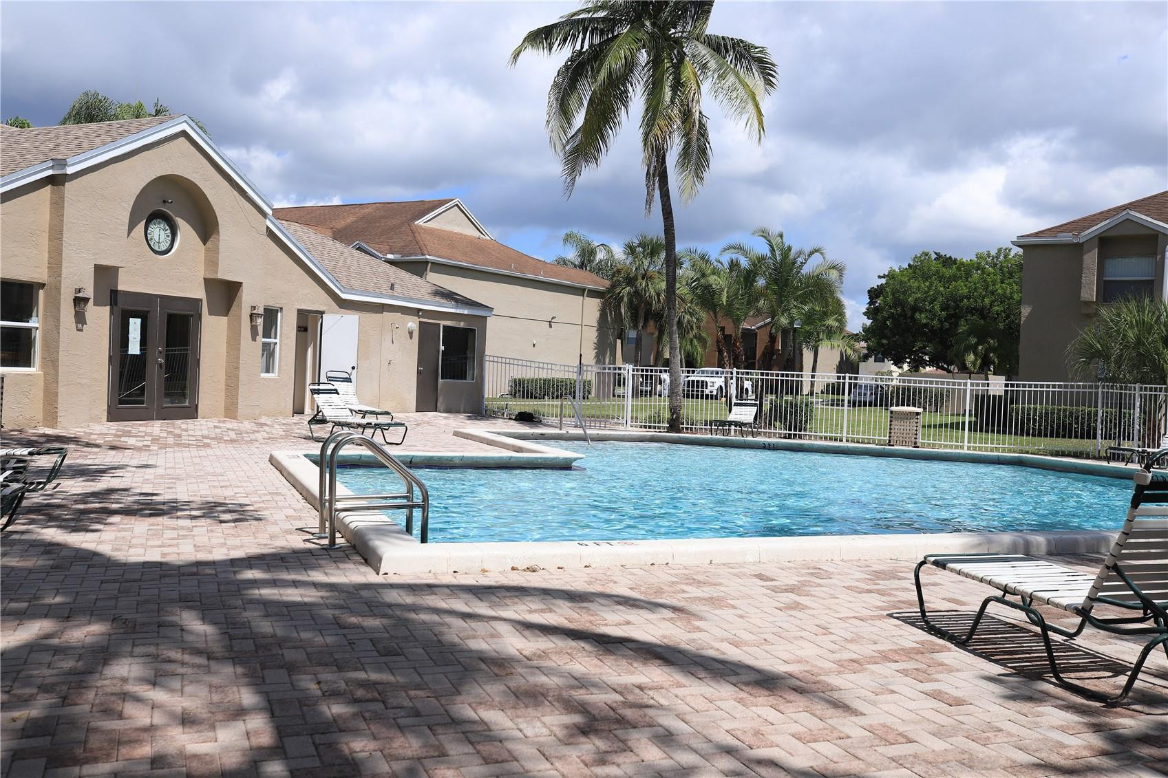 231 Southwest 113th Way, Unit 231 Pembroke Pines, FL 33025 - Photo 26 of 26 a front view of a house with garden