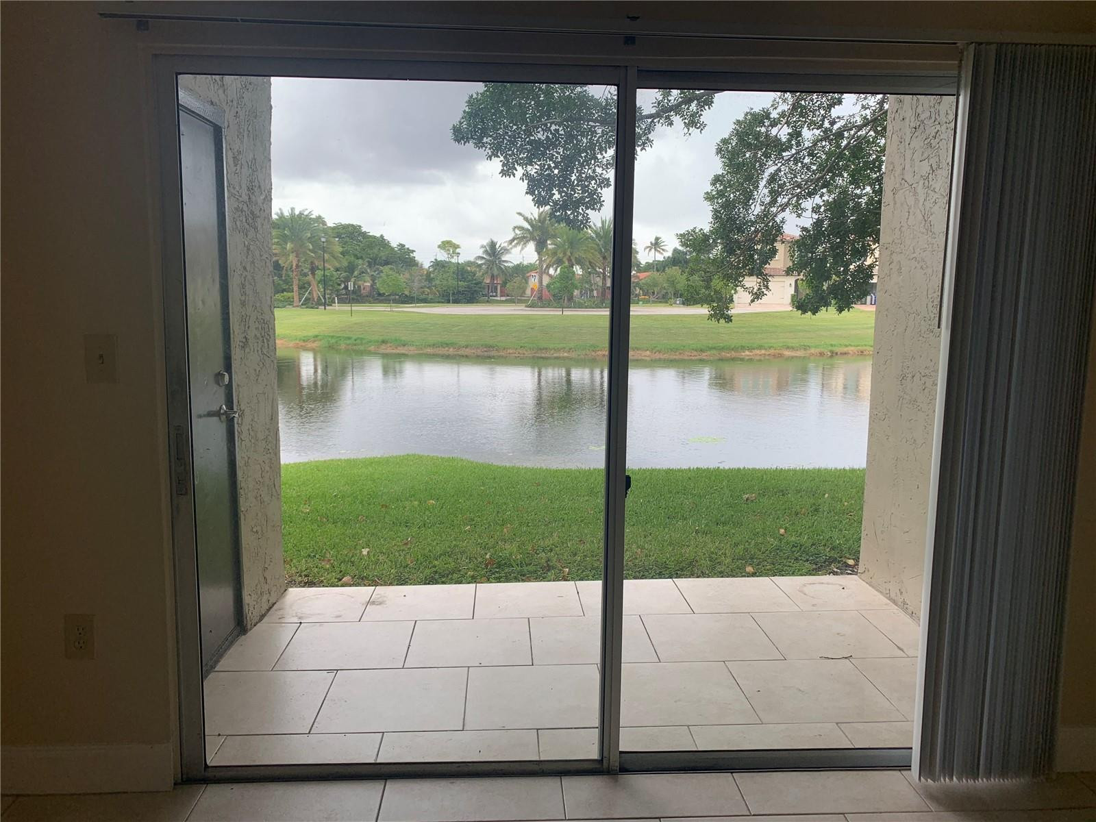 231 Southwest 113th Way, Unit 231 Pembroke Pines, FL 33025 - Photo 4 of 26 a view of backyard from a window