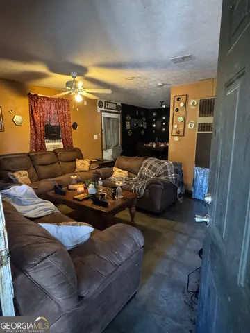 a bedroom with furniture and a large window