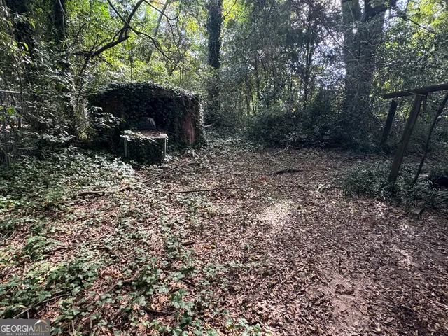 a view of a backyard with large trees