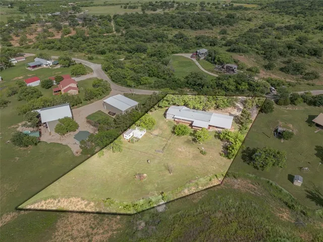 an aerial view of residential houses with outdoor space