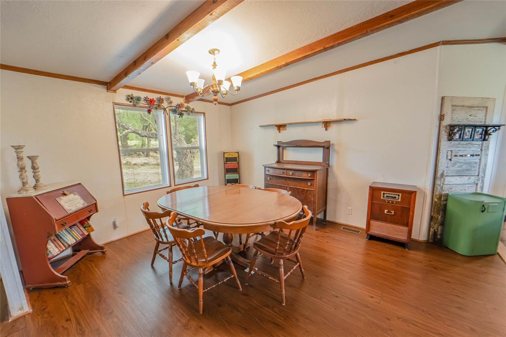 4942 County Road 206 Breckenridge, TX 76424 - Photo 16 of 40 a view of a dining room with furniture window and wooden floor