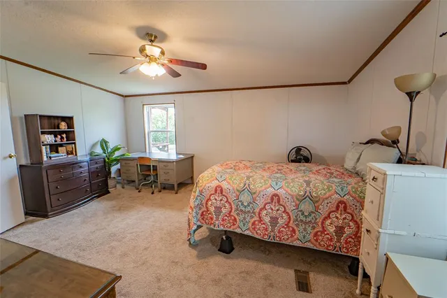 a bedroom with bed and window