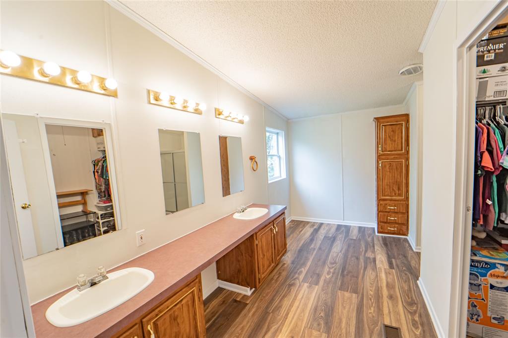 4942 County Road 206 Breckenridge, TX 76424 - Photo 25 of 40 a bathroom with a sink and a mirror
