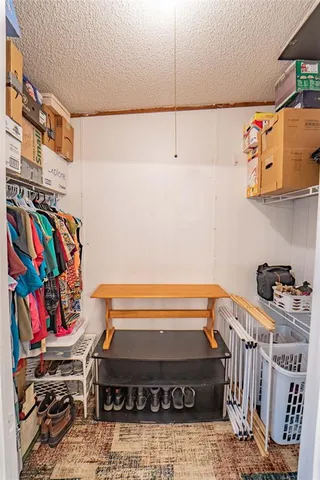 a view of storage and utility room with racks on the wall