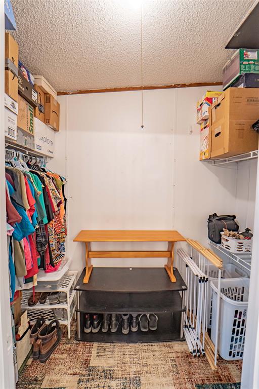 4942 County Road 206 Breckenridge, TX 76424 - Photo 28 of 40 a view of storage and utility room with racks on the wall