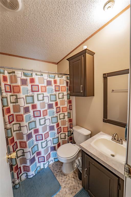 4942 County Road 206 Breckenridge, TX 76424 - Photo 32 of 40 a bathroom with a sink toilet and shower