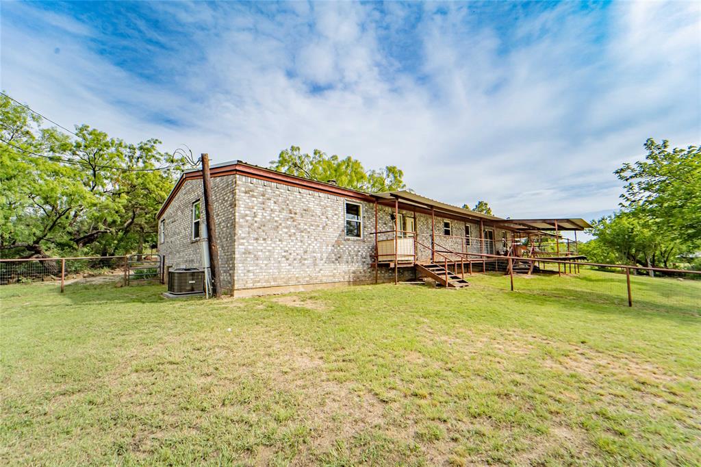 4942 County Road 206 Breckenridge, TX 76424 - Photo 35 of 40 a view of a house with a big yard and a large tree