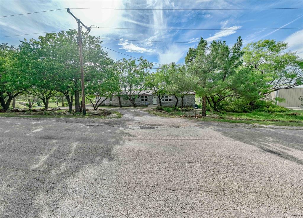 4942 County Road 206 Breckenridge, TX 76424 - Photo 10 of 40 a view of a dirt road with large trees