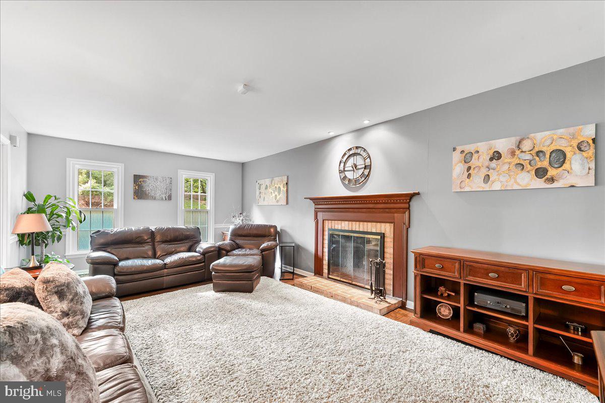 686 Limehouse Road Wayne, PA 19087 - Photo 3 of 51 a living room with furniture a window and a fireplace
