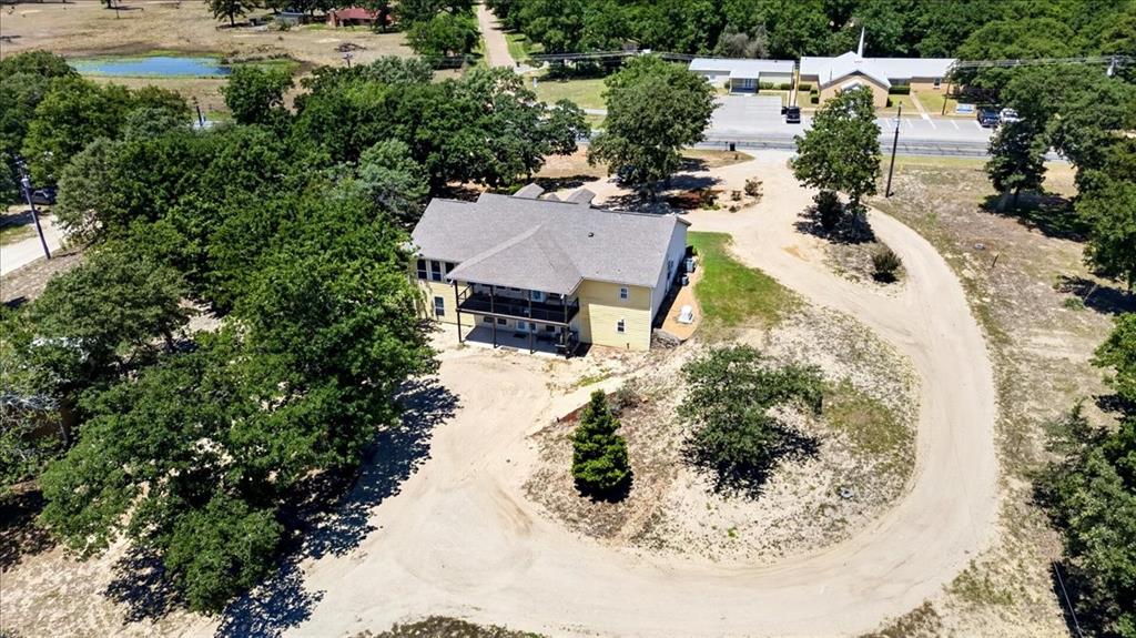 11591 Farm To Market 59 Athens, TX 75751 - Photo 34 of 40 Tan multi-level residence featuring an upper-level balcony and lower-level patio on 9.2 acres at 11591 FM 59 Athens TX 75751 in Crossroads ISD located in Henderson county of Texas.