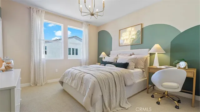 a bed room with two bed and a chandelier