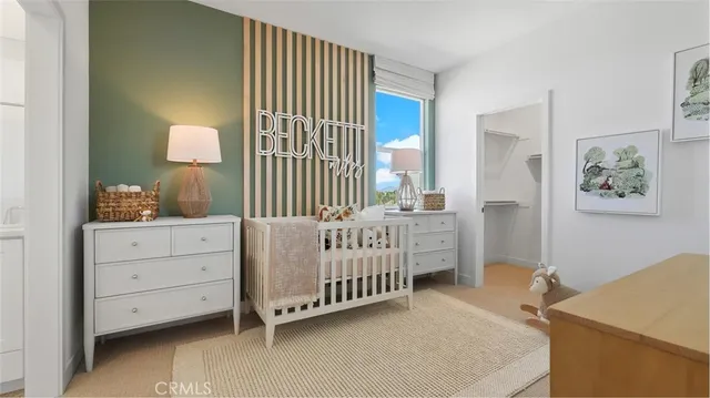 a bedroom with a baby bed dresser and a window