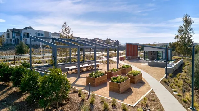 a view of a patio with couches chairs potted plants and water view