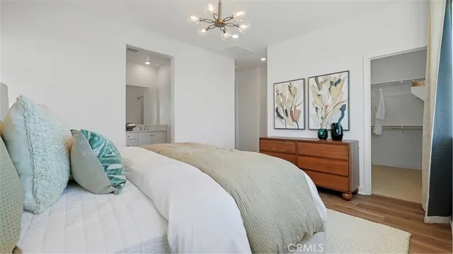a bedroom with a large bed and a chandelier