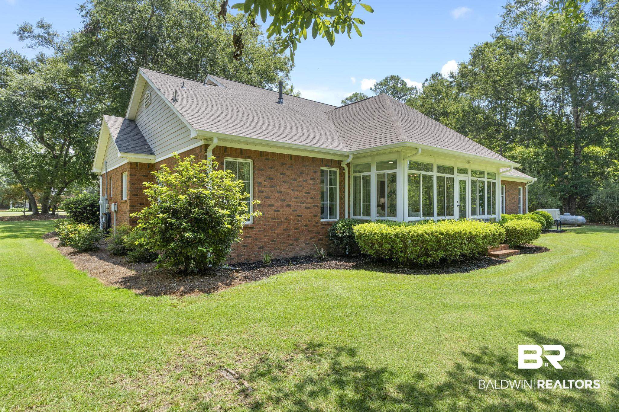 4451 Millhouse Road Gulf Shores, AL 36542 - Photo 43 of 50 View of front of home featuring a sunroom and a front yard