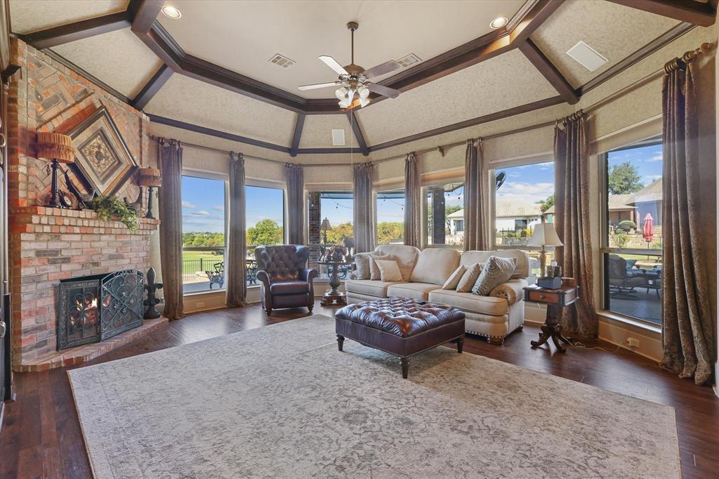 2021 Kings Pass Heath, TX 75032 - Photo 11 of 37 a living room with furniture a fireplace and a floor to ceiling window