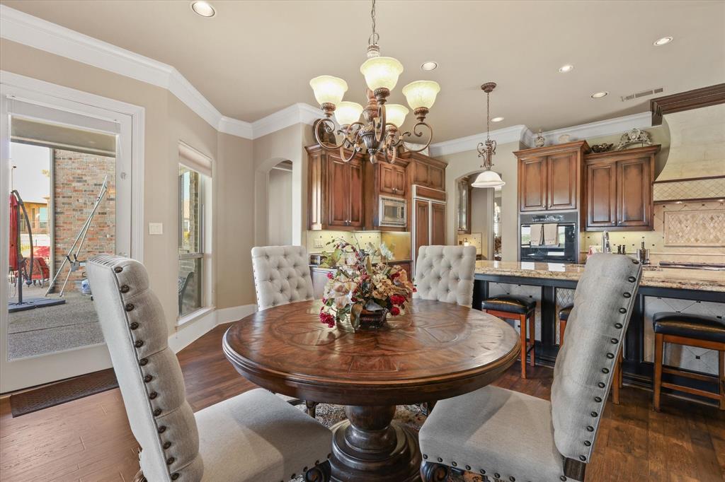 2021 Kings Pass Heath, TX 75032 - Photo 12 of 37 a view of a dining room with furniture and wooden floor