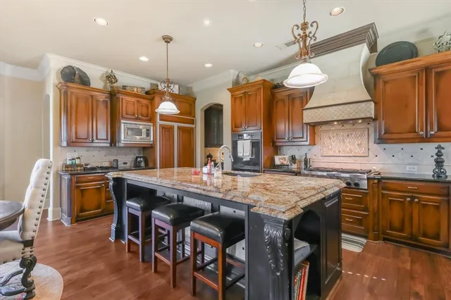 a kitchen with a table chairs sink and cabinets