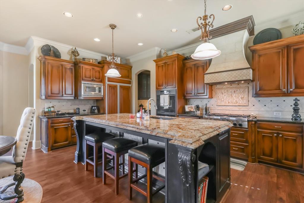2021 Kings Pass Heath, TX 75032 - Photo 15 of 37 a kitchen with a table chairs sink and cabinets