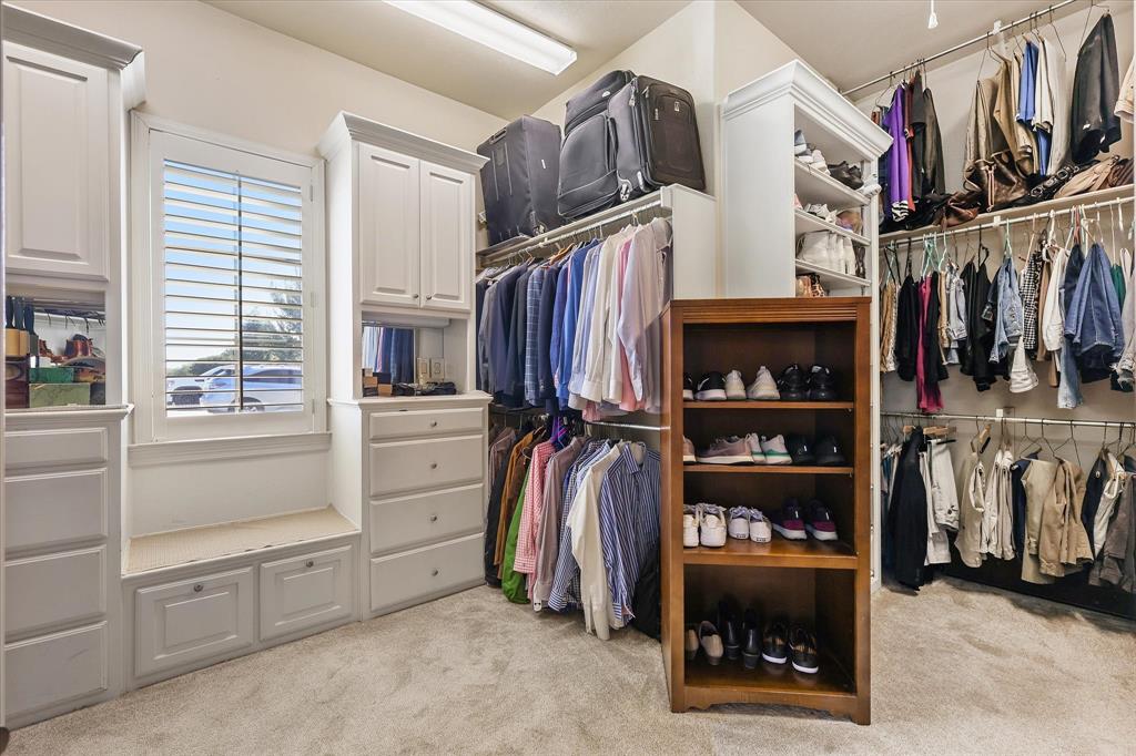 2021 Kings Pass Heath, TX 75032 - Photo 18 of 37 a view of walk in closet with clothes and shoes