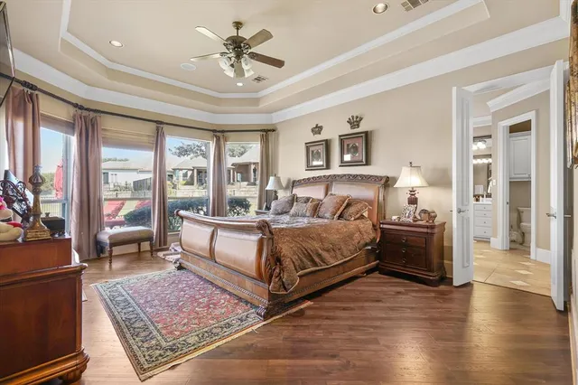 a spacious bedroom with a large bed a rug and windows