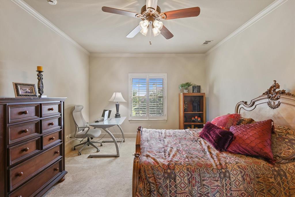 2021 Kings Pass Heath, TX 75032 - Photo 20 of 37 a bedroom with a bed and a chandelier
