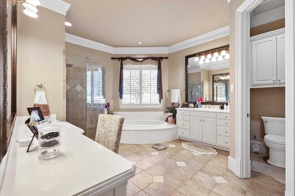 2021 Kings Pass Heath, TX 75032 - Photo 21 of 37 a large white bathroom with sink mirror and bathtub