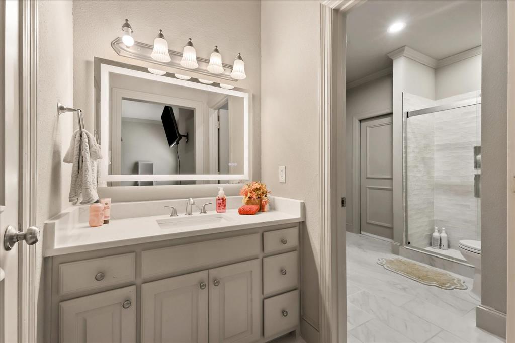 2021 Kings Pass Heath, TX 75032 - Photo 22 of 37 a bathroom with a sink and a mirror