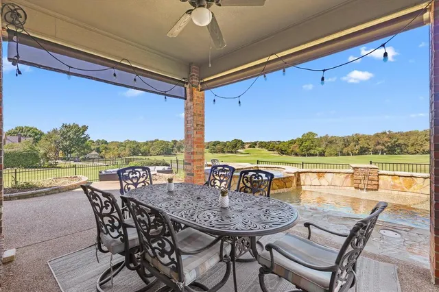 a view of a lake with a table and chairs