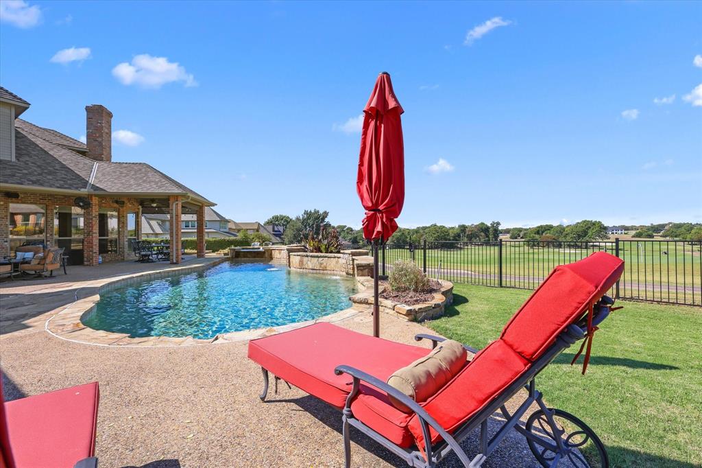 2021 Kings Pass Heath, TX 75032 - Photo 28 of 37 a view of a backyard with sitting area and slide
