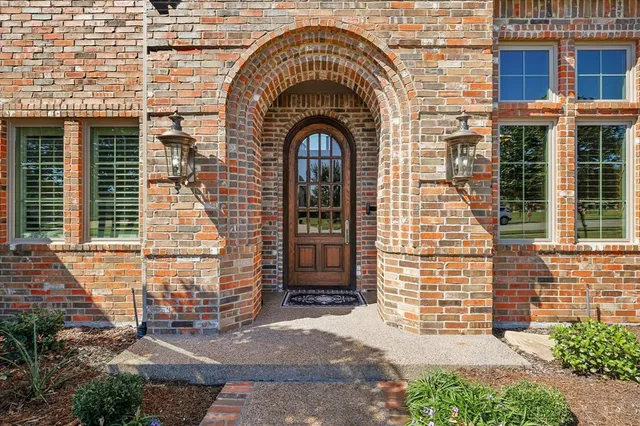 a view of a brick house with large windows